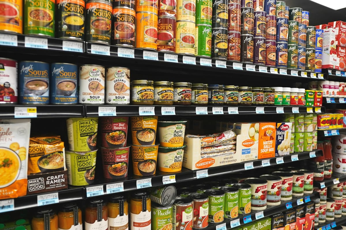 Grocery store shelves stocked with canned soups, ramen cups and boxed soup mixes